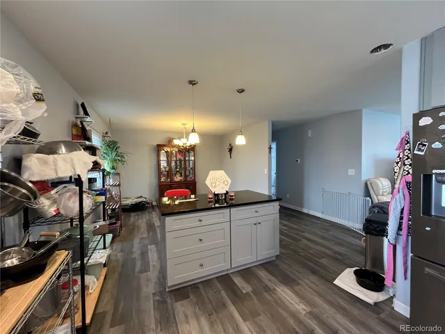 a room with gym equipment and wooden floor