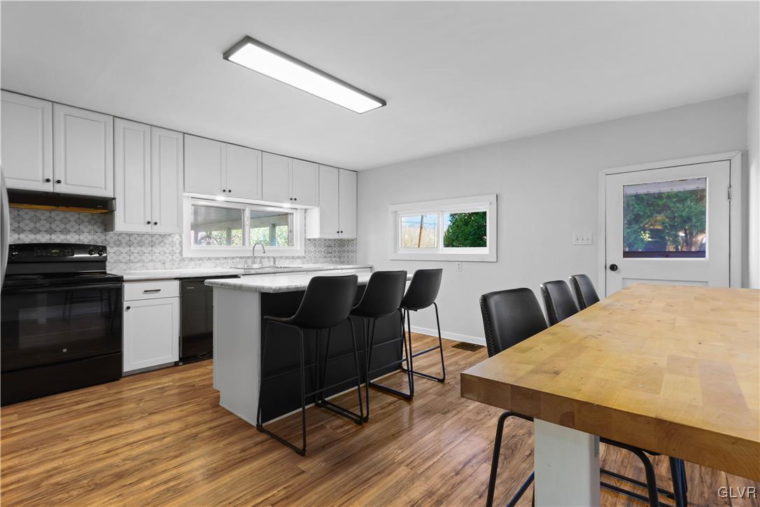 1802 Moselem Spring Road Hamburg, PA 19526 - Photo 18 of 54 a kitchen with a table chairs refrigerator and microwave