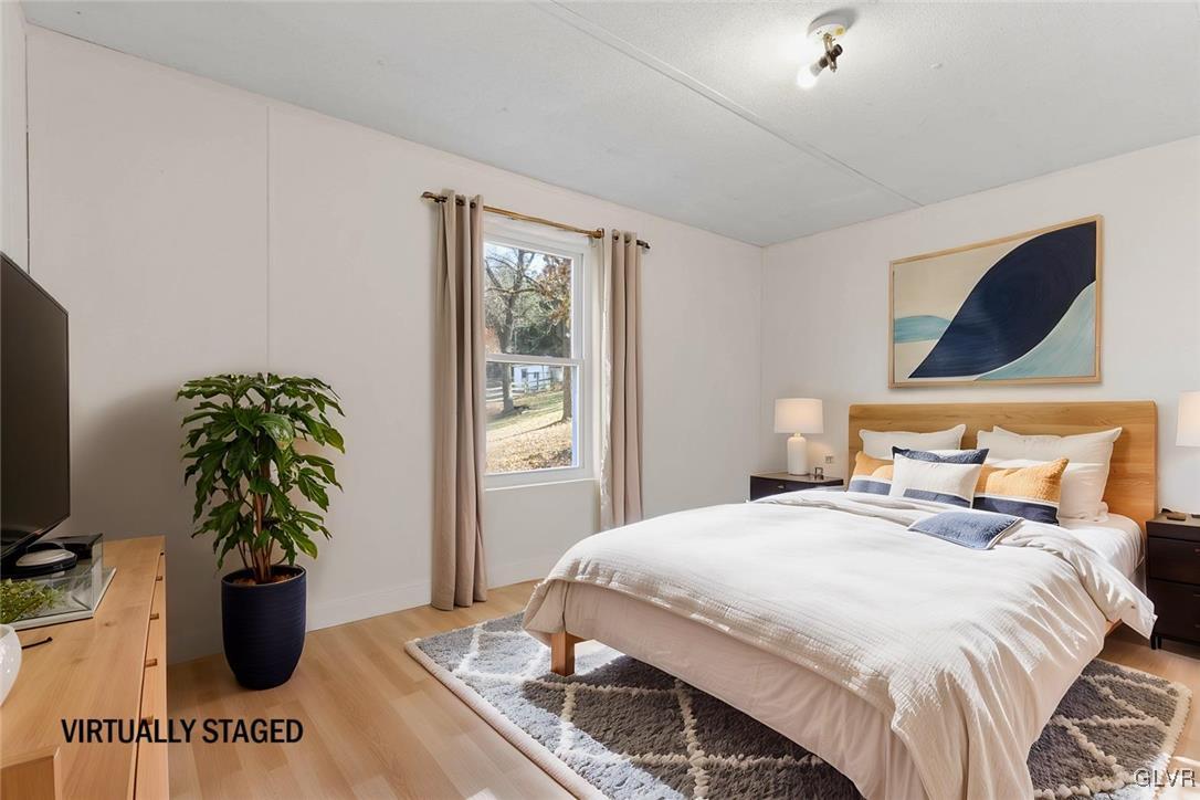 1802 Moselem Spring Road Hamburg, PA 19526 - Photo 44 of 54 a bedroom with a bed and a potted plant