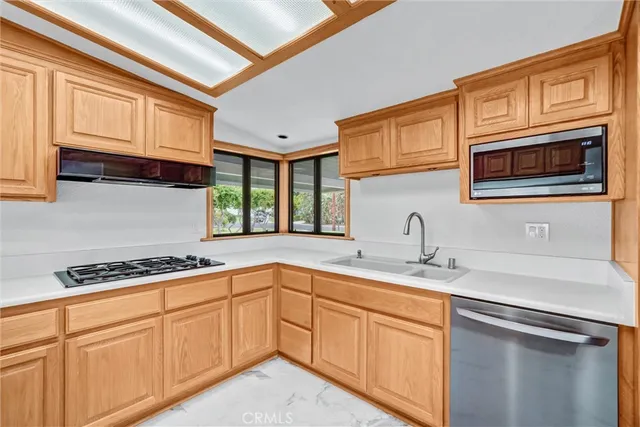 a bathroom with a sink a light fixture and a toilet