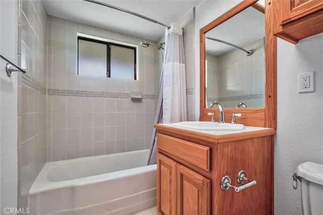 an empty room with a window and a ceiling fan