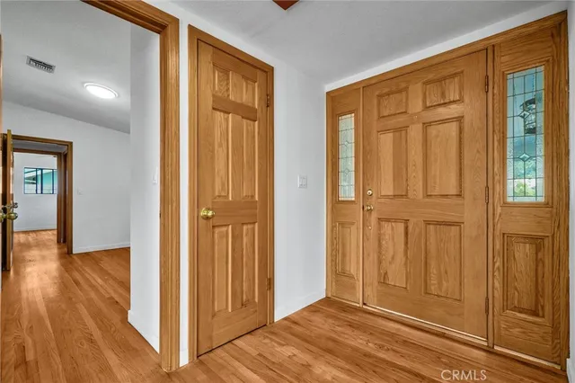 a view of a kitchen with wooden floor and a refrigerator