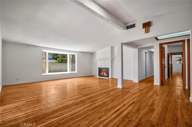 a view of a dining room with furniture and a potted plant