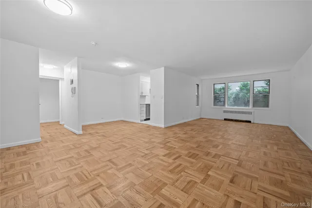 a view of empty room with a fireplace and window