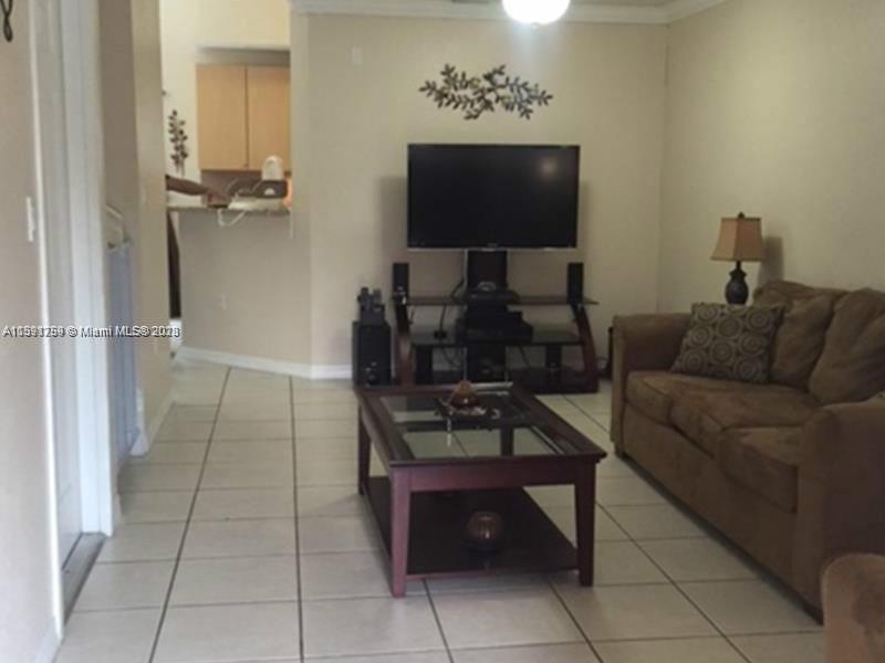 22241 Southwest 88th Path Cutler Bay, FL 33190 - Photo 2 of 9 a living room with furniture and a flat screen tv