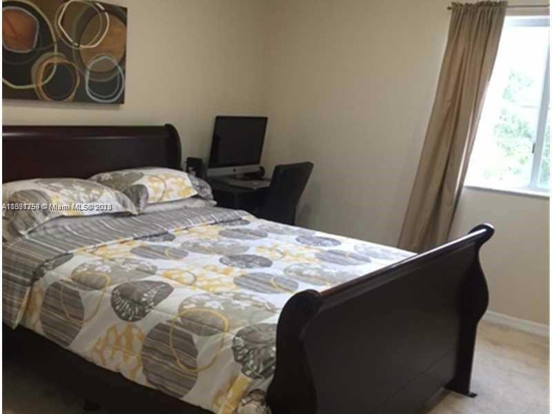 22241 Southwest 88th Path Cutler Bay, FL 33190 - Photo 4 of 9 a bedroom with a bed and chair