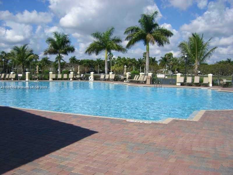 22241 Southwest 88th Path Cutler Bay, FL 33190 - Photo 7 of 9 a view of a swimming pool and a chair