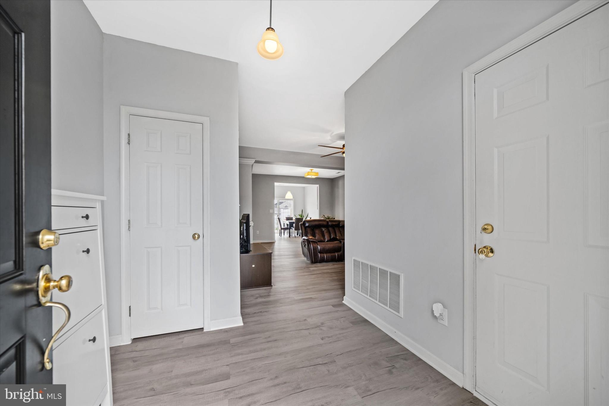 128 Springfield Circle Middletown, DE 19709 - Photo 3 of 22 a view of a hallway to closet and wooden floor