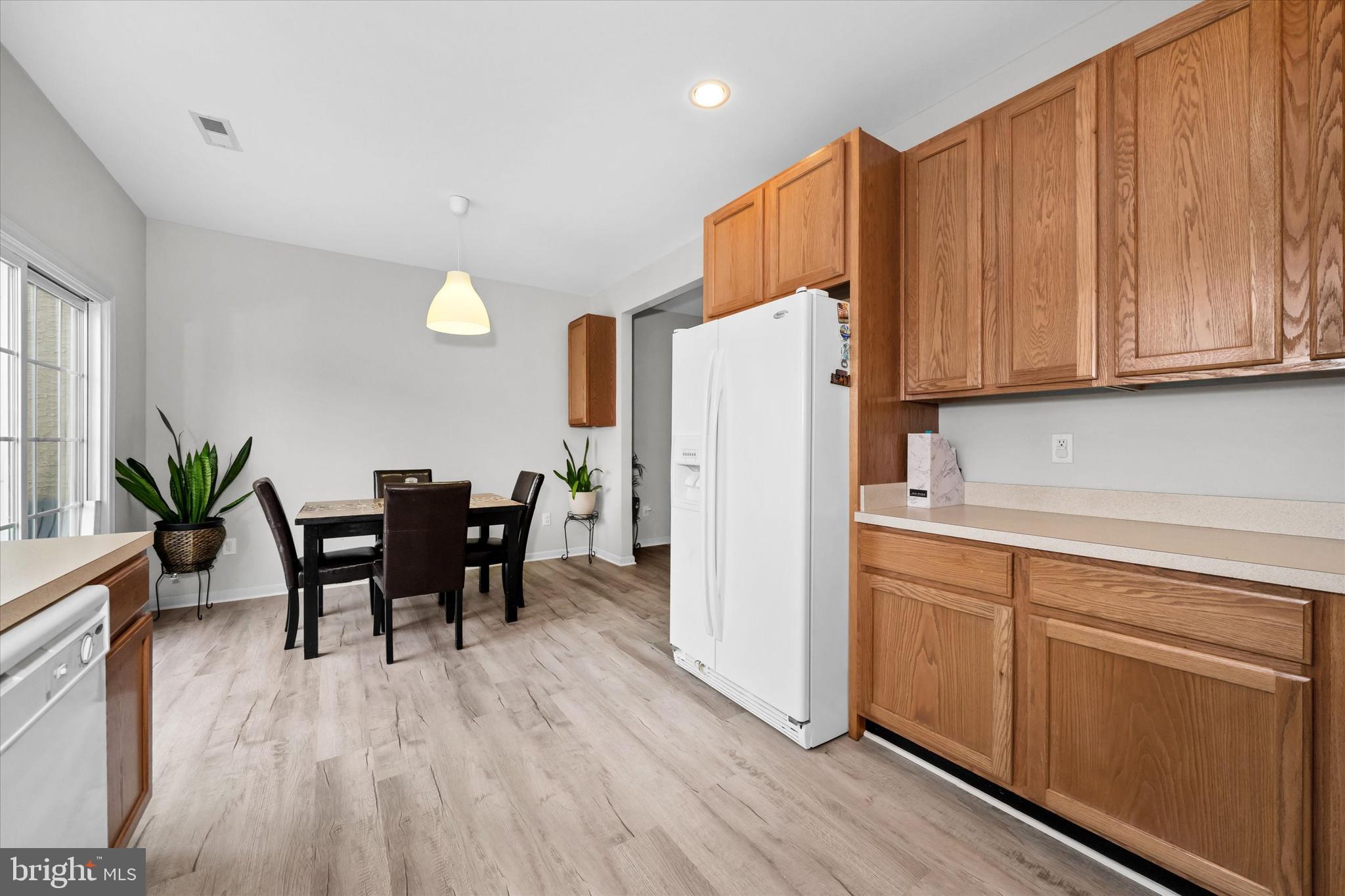 128 Springfield Circle Middletown, DE 19709 - Photo 8 of 22 a kitchen with granite countertop wooden floors white cabinets and stainless steel appliances