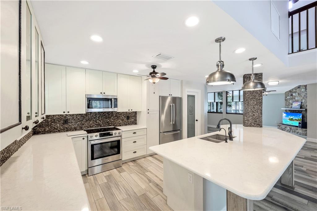 17680 Wildcat Drive Fort Myers, FL 33913 - Photo 11 of 50 a kitchen with stainless steel appliances a sink stove and refrigerator