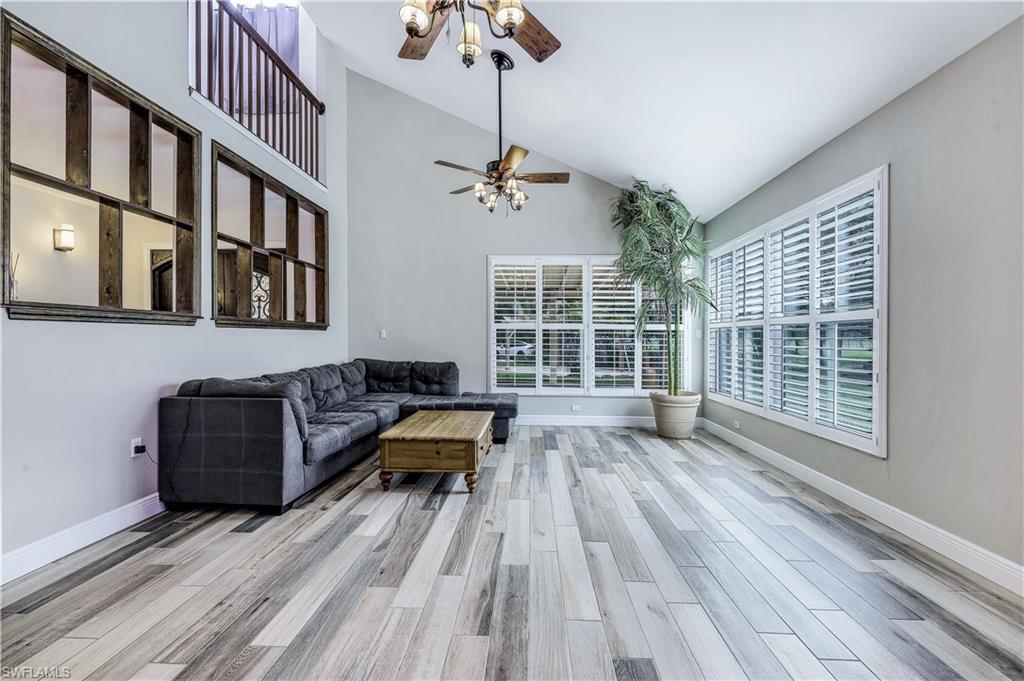 17680 Wildcat Drive Fort Myers, FL 33913 - Photo 17 of 50 a living room with furniture fireplace and wooden floor
