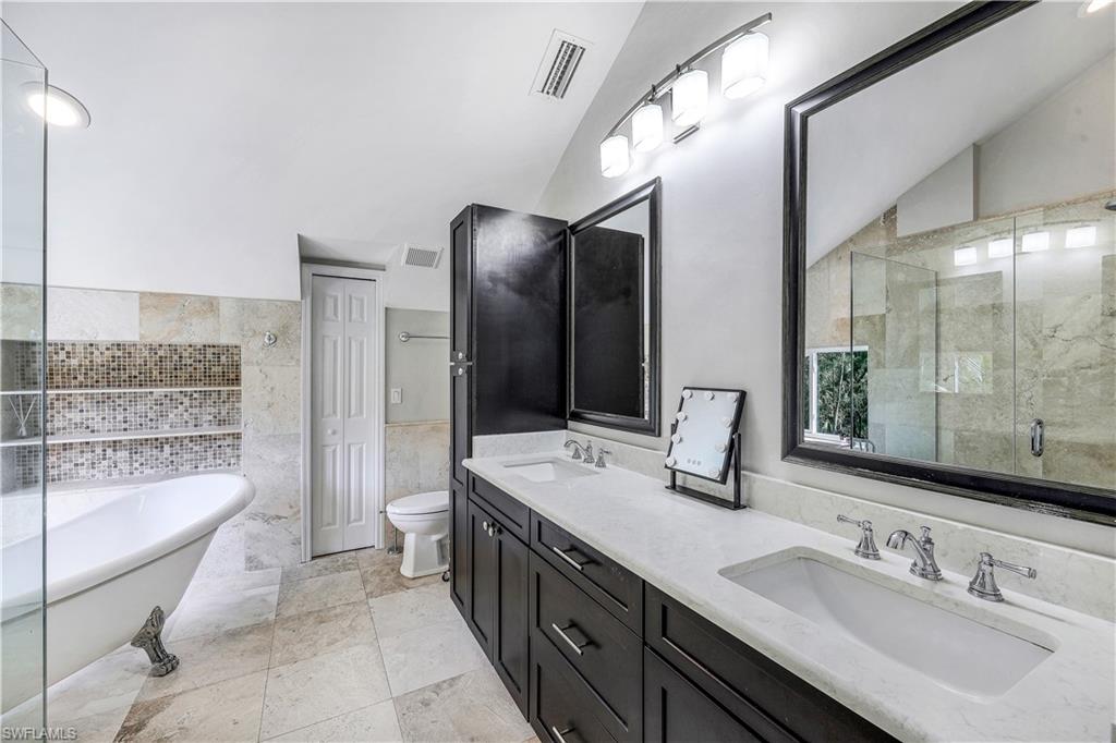 17680 Wildcat Drive Fort Myers, FL 33913 - Photo 26 of 50 a bathroom with a double vanity sink a mirror and a bathtub