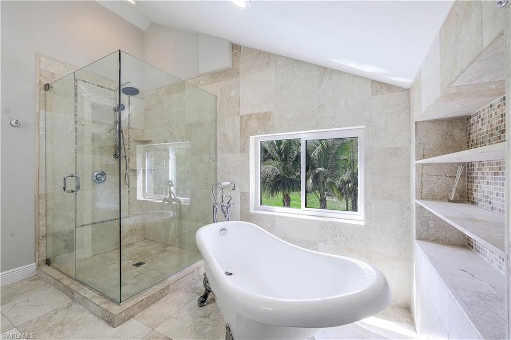 17680 Wildcat Drive Fort Myers, FL 33913 - Photo 27 of 50 a bathroom with a bathtub and shower