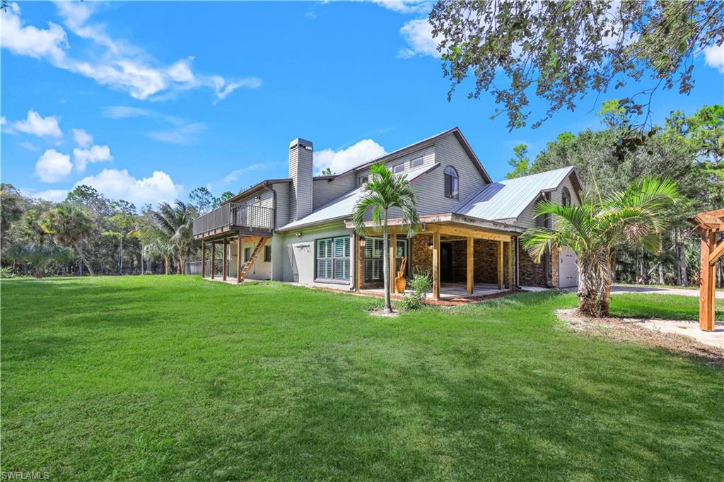 17680 Wildcat Drive Fort Myers, FL 33913 - Photo 42 of 50 a view of a house next to a big yard with plants and large trees