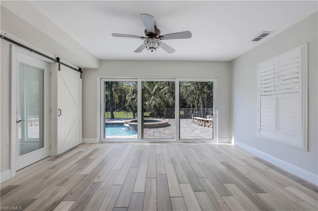 17680 Wildcat Drive Fort Myers, FL 33913 - Photo 7 of 50 an empty room with wooden floor and windows