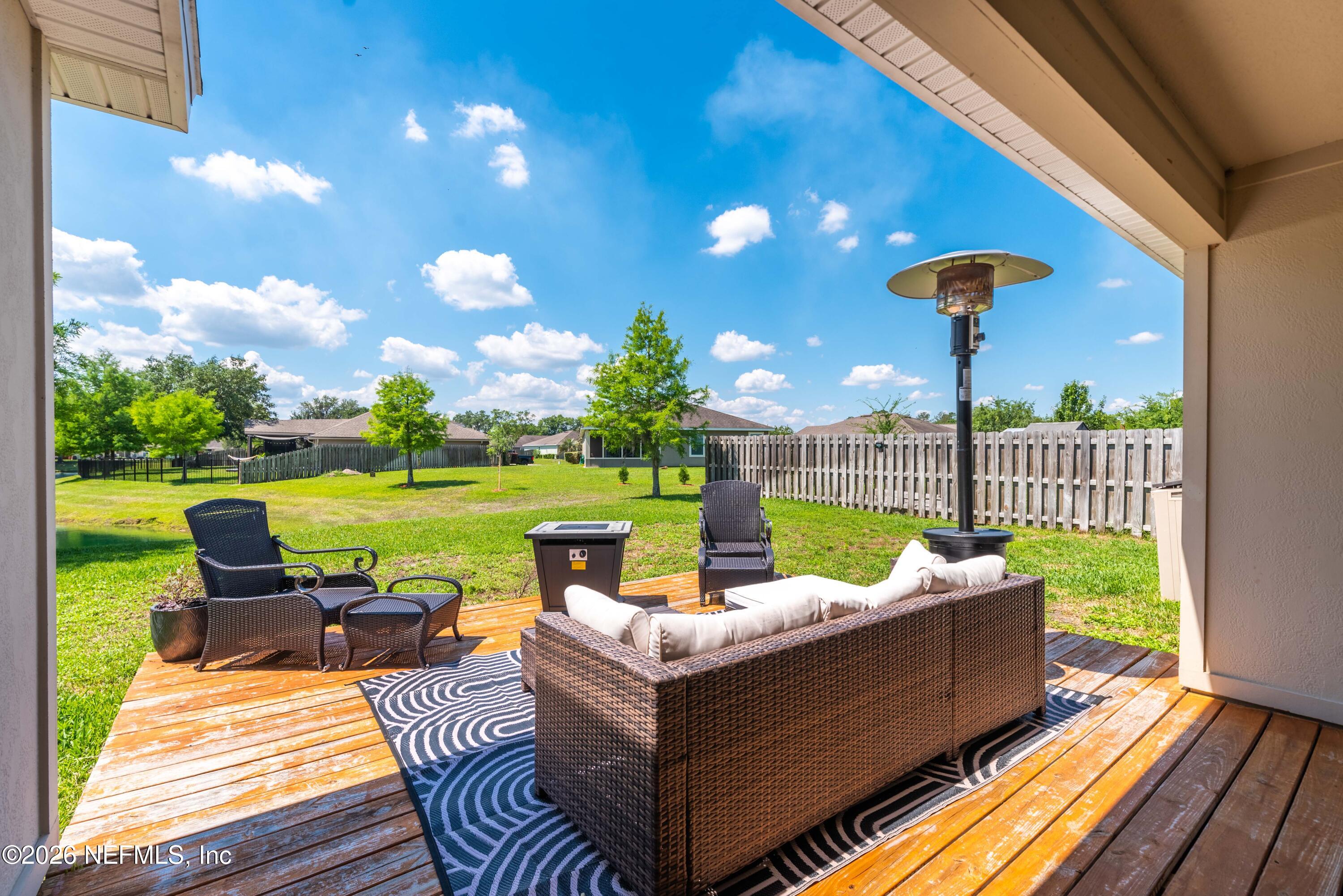 6178 Daylilly Road Macclenny, FL 32063 - Photo 26 of 29 a view of a patio with couches chairs and a yard