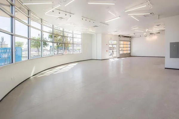 an empty room with windows and view of an empty room