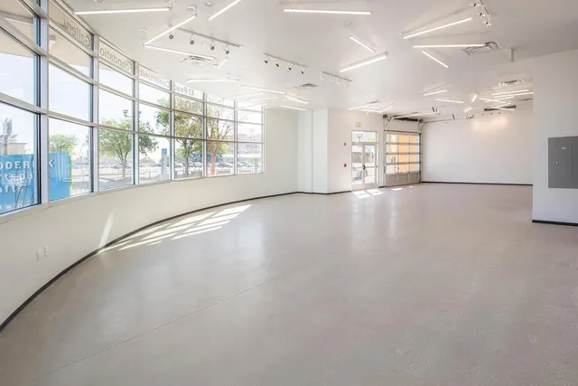 an empty room with windows and view of an empty room