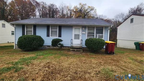 a view of a house with a yard and a large tree