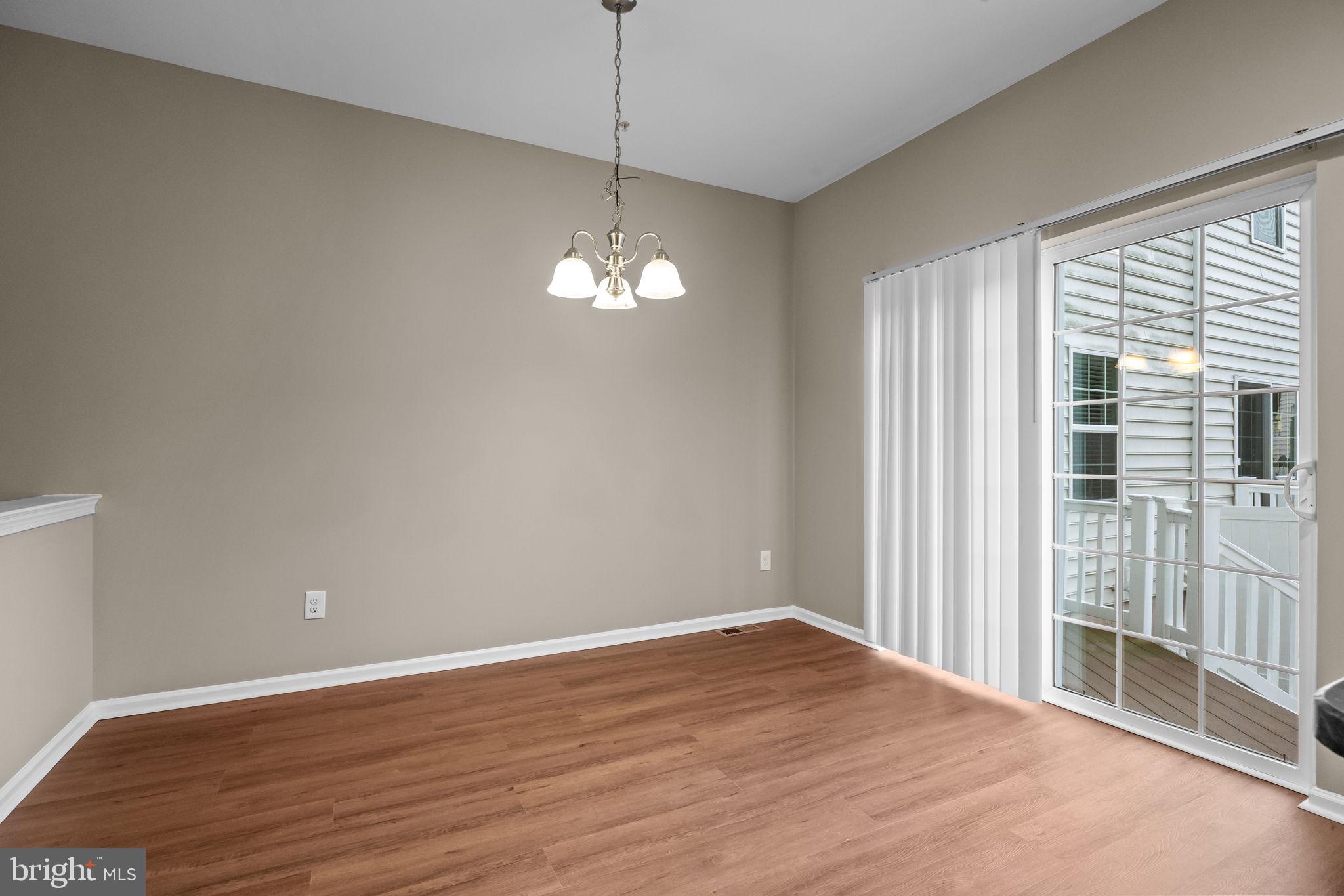 3880 Cephas Child Road, Unit 11 Doylestown, PA 18902 - Photo 11 of 34 a view of empty room with wooden floor and chandelier