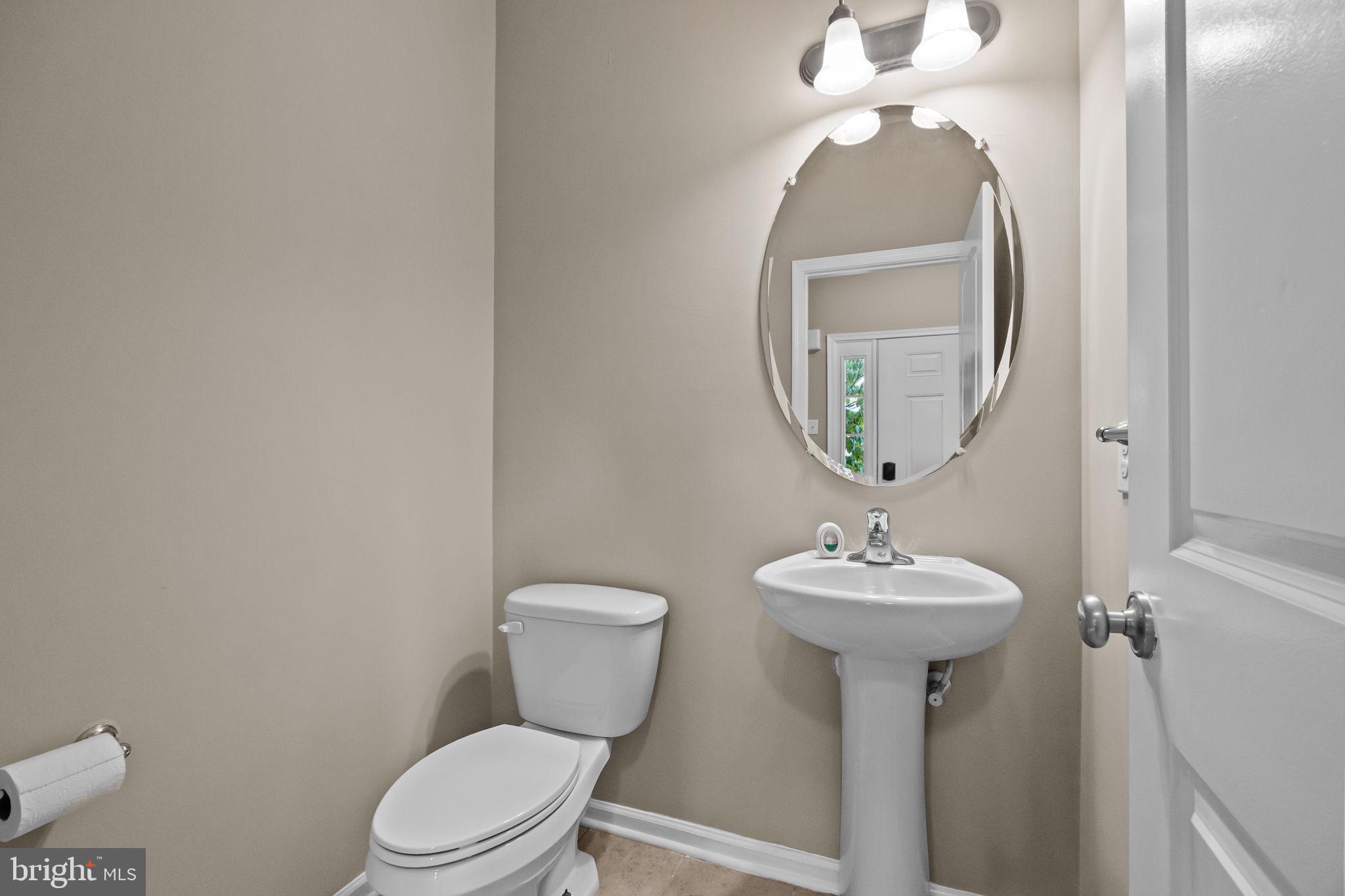 3880 Cephas Child Road, Unit 11 Doylestown, PA 18902 - Photo 12 of 34 a bathroom with a toilet sink and mirror