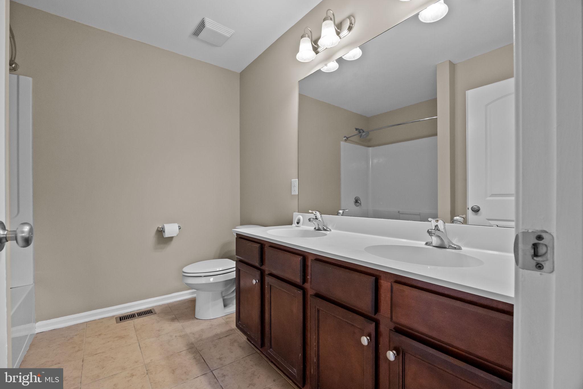 3880 Cephas Child Road, Unit 11 Doylestown, PA 18902 - Photo 17 of 34 a bathroom with a double vanity sink and a mirror
