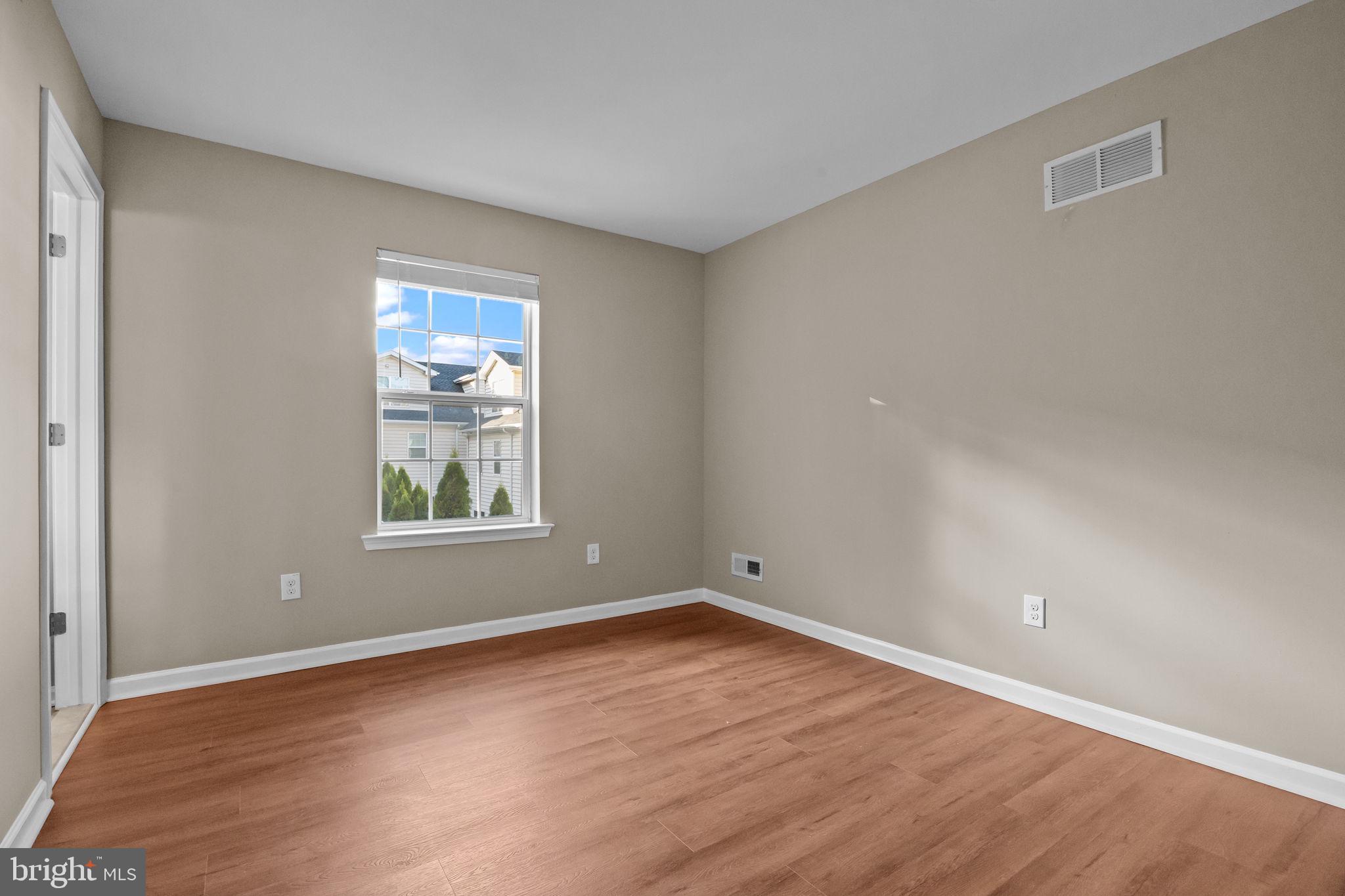 3880 Cephas Child Road, Unit 11 Doylestown, PA 18902 - Photo 19 of 34 wooden floor in an empty room with a window