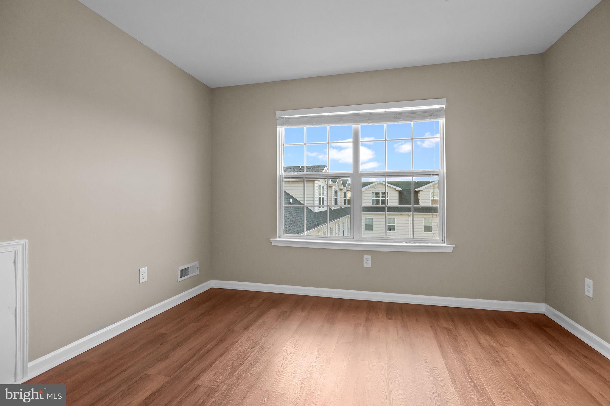 3880 Cephas Child Road, Unit 11 Doylestown, PA 18902 - Photo 26 of 34 a view of an empty room with wooden floor and a window