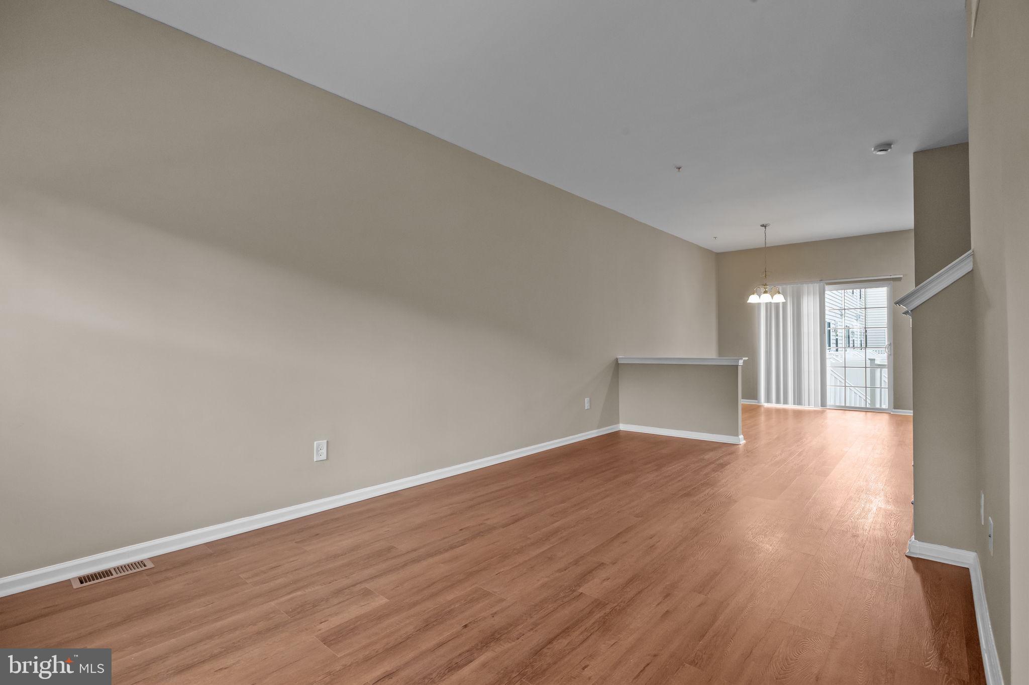 3880 Cephas Child Road, Unit 11 Doylestown, PA 18902 - Photo 5 of 34 a view of an empty room with wooden floor and a window