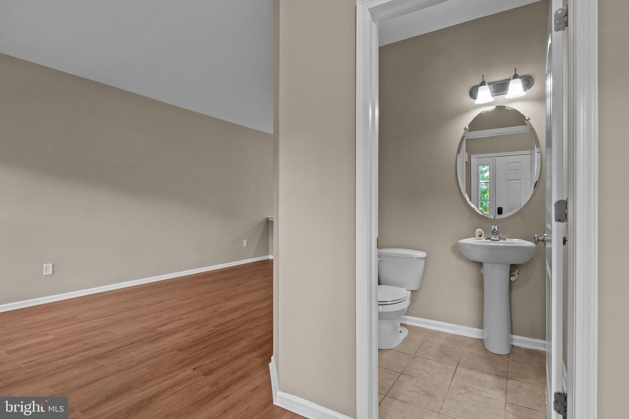 3880 Cephas Child Road, Unit 11 Doylestown, PA 18902 - Photo 6 of 34 a view of a hallway with wooden floor and a bathroom