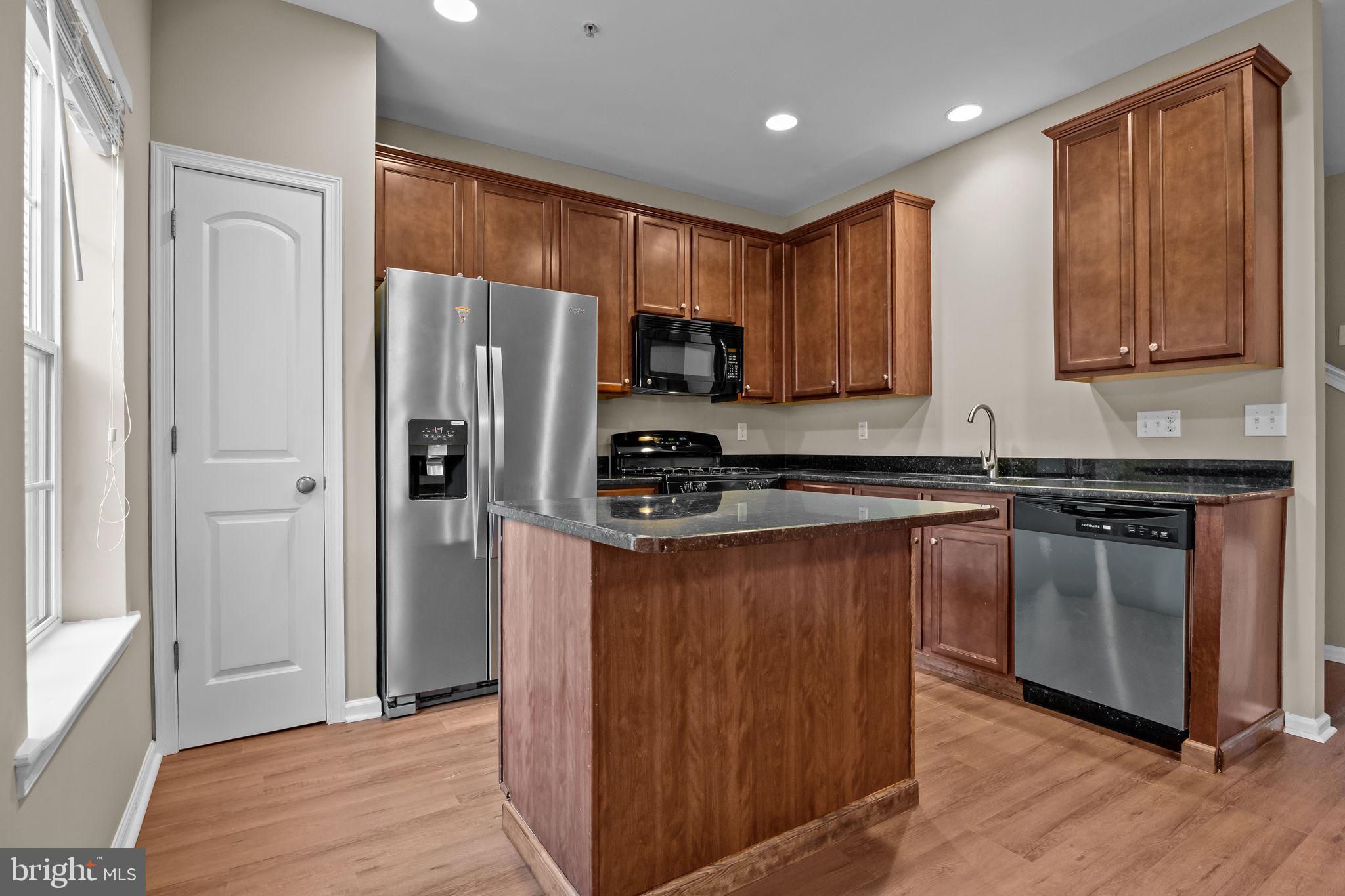 3880 Cephas Child Road, Unit 11 Doylestown, PA 18902 - Photo 9 of 34 a kitchen with stainless steel appliances granite countertop a refrigerator stove and sink