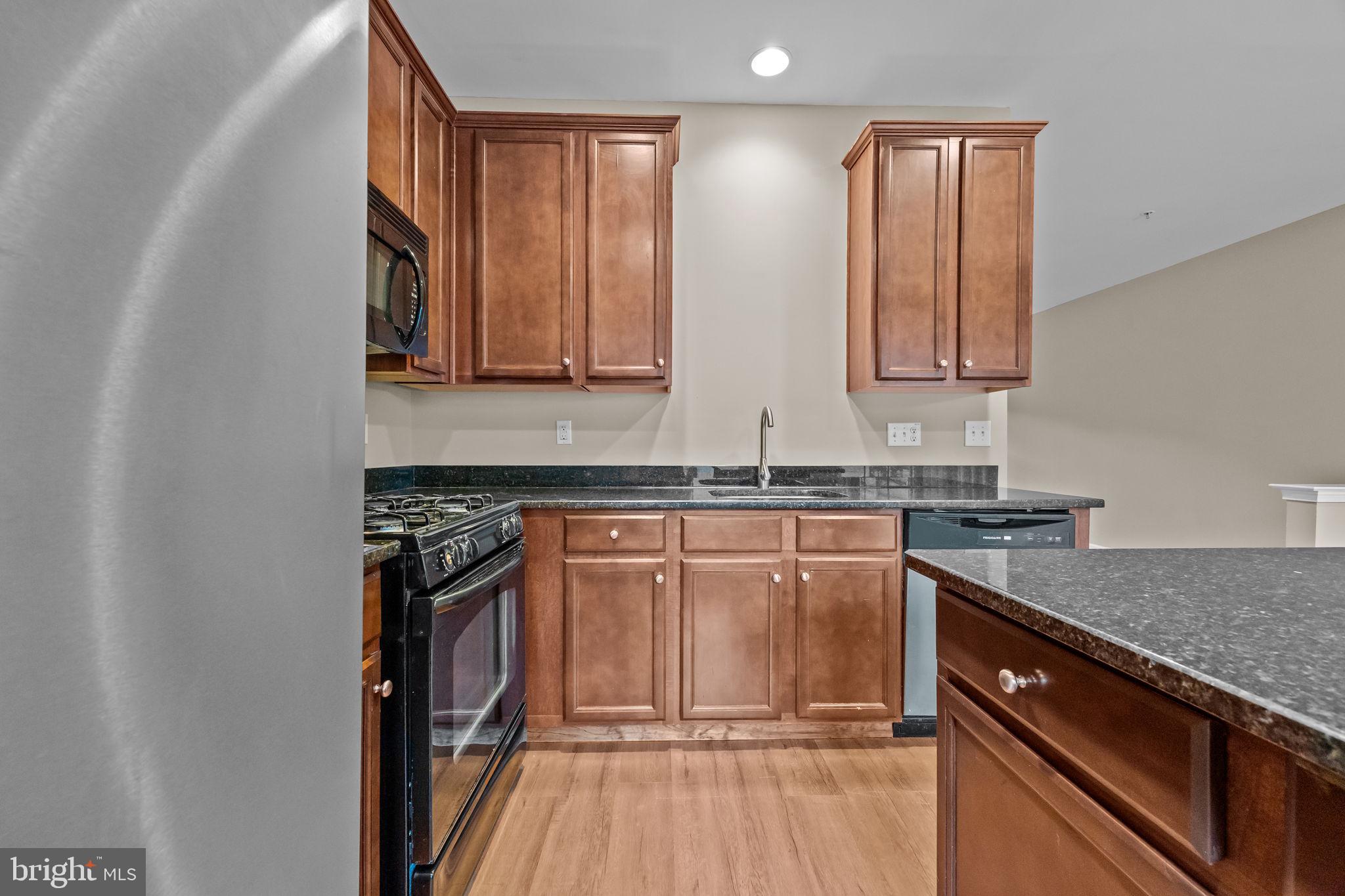 3880 Cephas Child Road, Unit 11 Doylestown, PA 18902 - Photo 10 of 34 a kitchen with stainless steel appliances granite countertop a sink stove and cabinets
