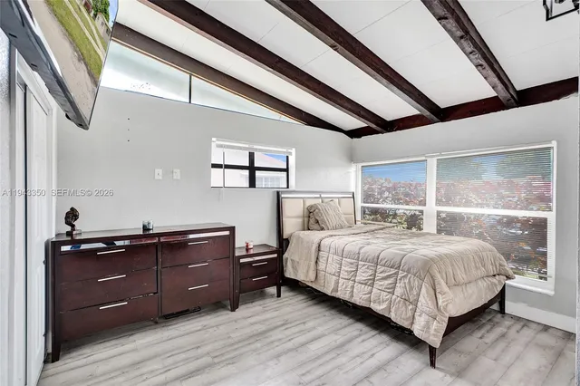 a bedroom with a bed and window