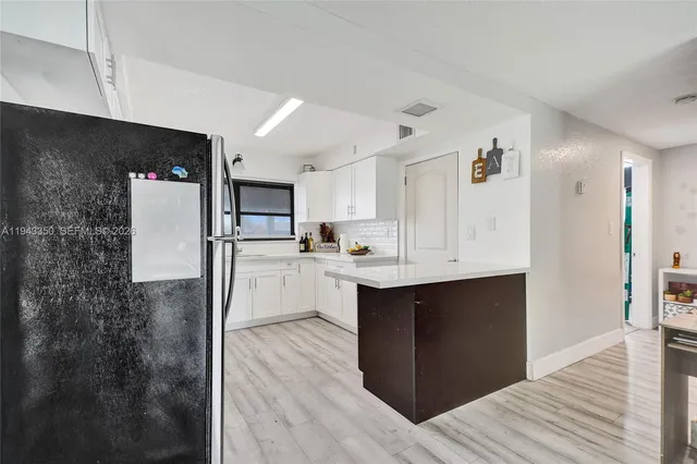 a kitchen with stainless steel appliances a refrigerator and a stove top oven