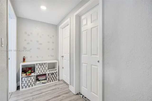 a view of a hallway with wooden floor and staircase
