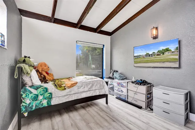 a bedroom with bed and a window