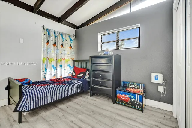 a bedroom with a bed and a dresser