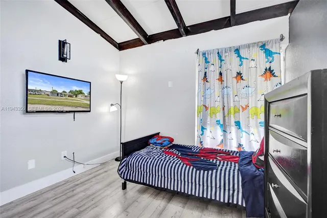 a bedroom with a bed and a refrigerator