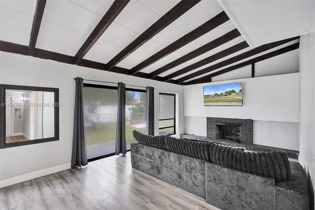 a bedroom with furniture and large window