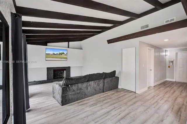 a living room with a couch and a wooden floor