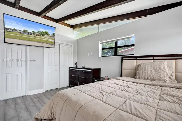 a bedroom with a bed and a view of bathroom