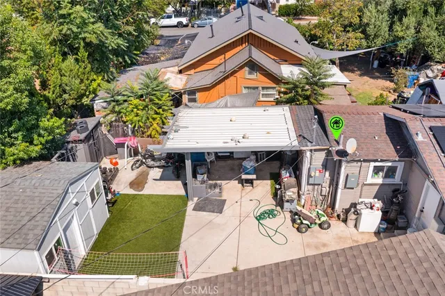 an aerial view of a house with garden space and seating area
