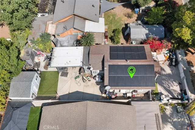 an aerial view of a house with yard and parking