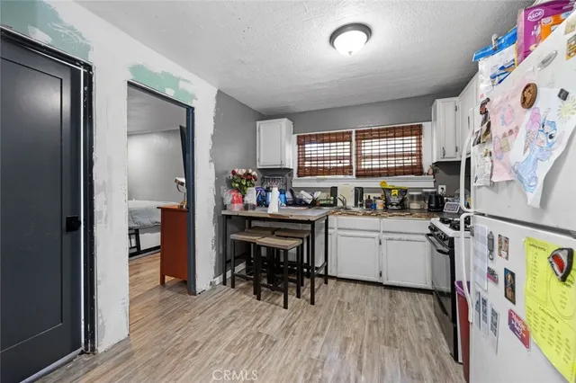 a kitchen with a refrigerator and a sink