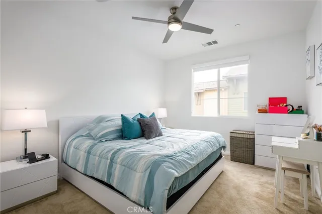a bedroom with a bed and a tv on the dresser