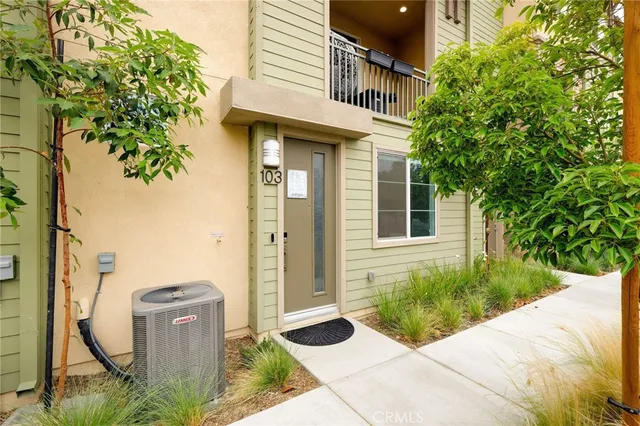 a view of a house with potted plants