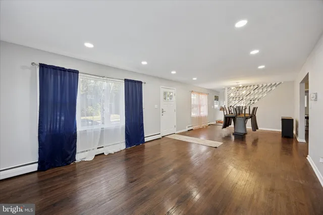 a view of empty room with wooden floor