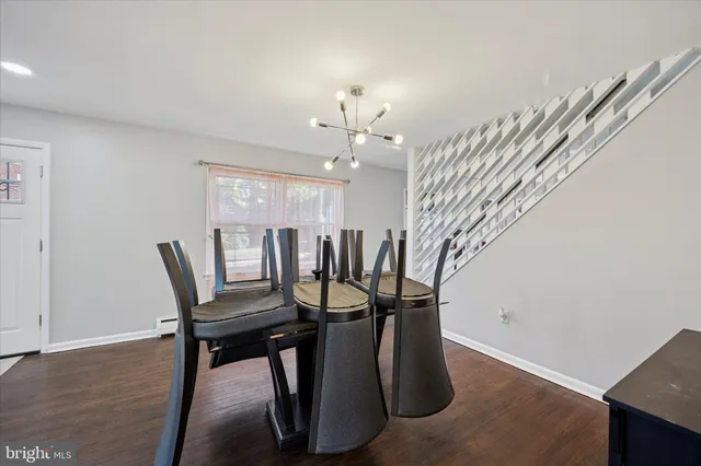 a view of a dining room with furniture and a chandelier
