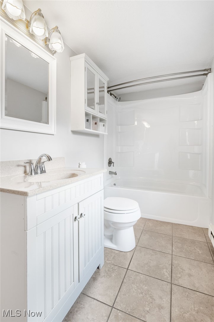 3696 Lynn Road Ravenna, OH 44266 - Photo 13 of 25 Full bathroom with toilet, shower / tub combination, vanity, and tile patterned floors