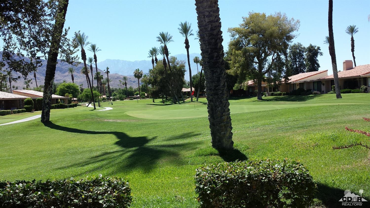 19 La Ronda Drive Rancho Mirage, CA 92270 - Photo 1 of 11 a view of a park with large trees